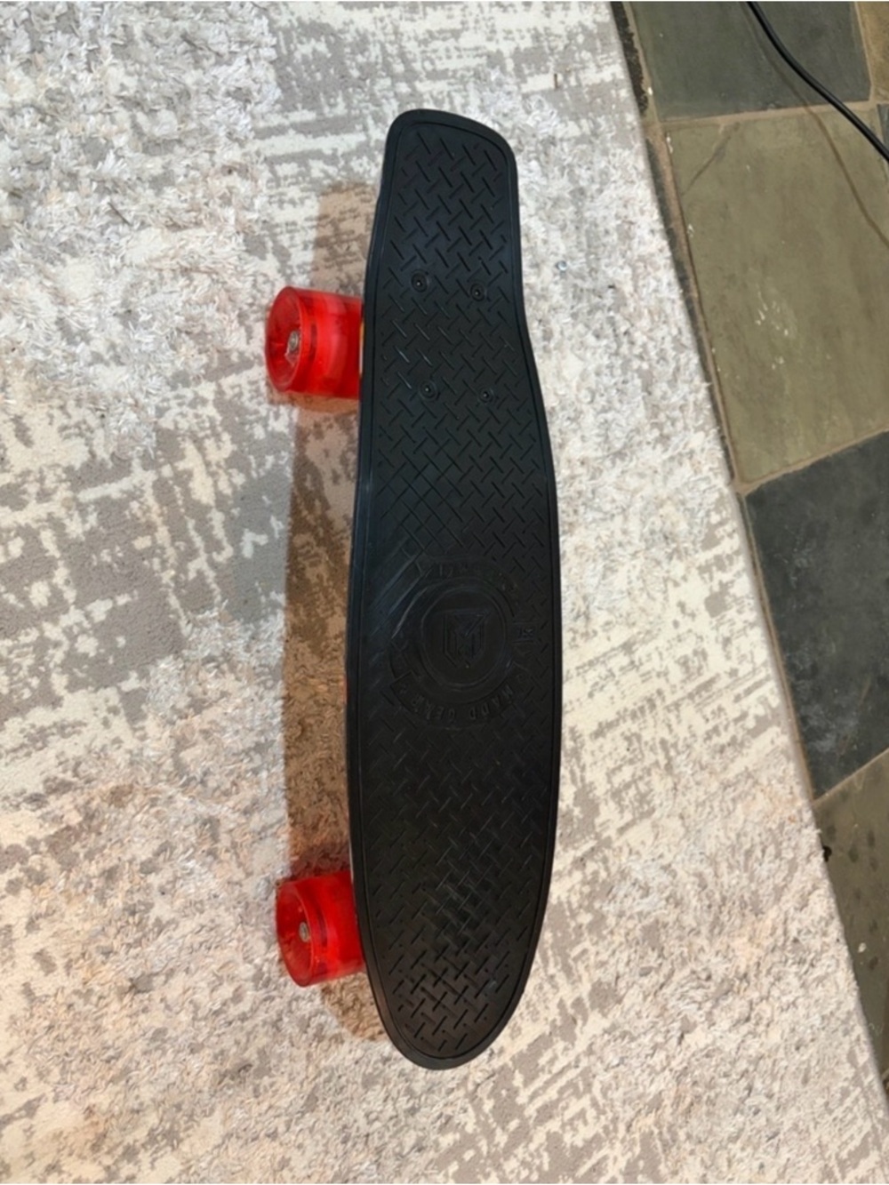 Kids Black Skateboard with Red Transparent Wheels. Wheels light up